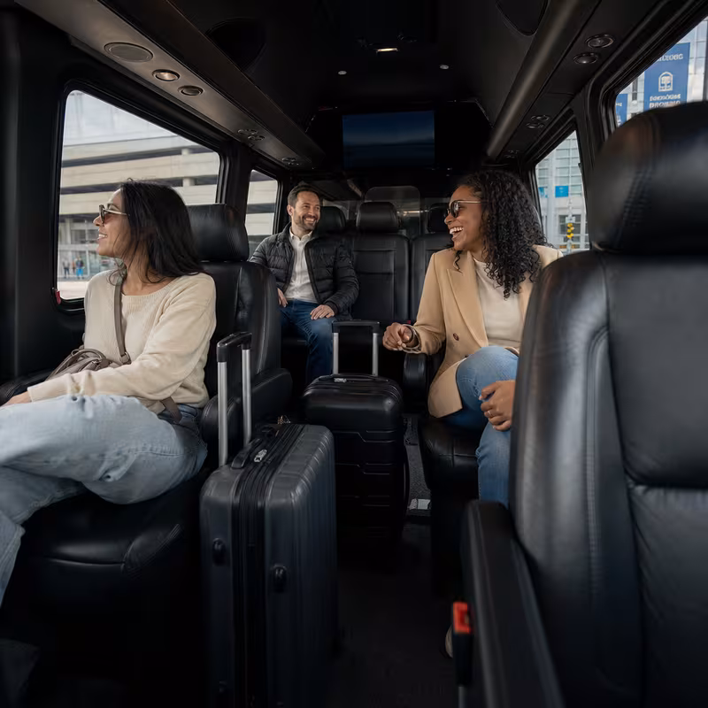Passengers loading luggage while boarding an Philadelphia group shuttle